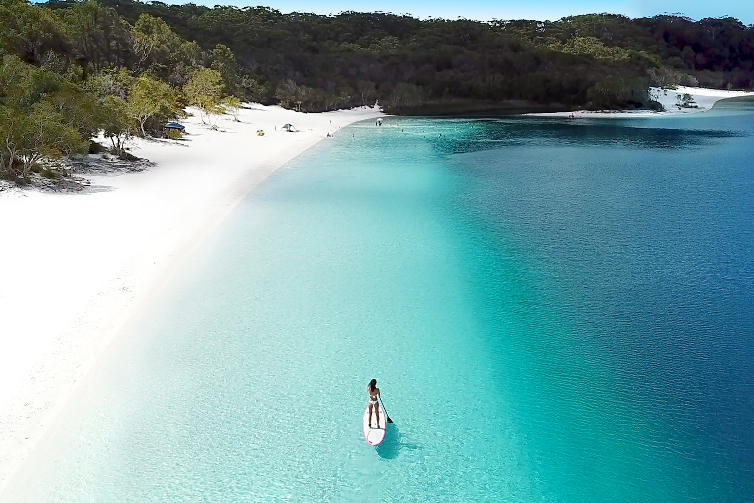 Aerial view of Fraser Island's pristine beaches and lush rainforests.